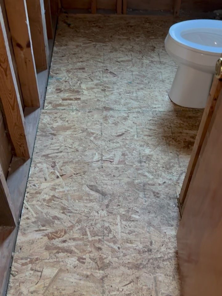 Before: bare subfloor, ready for the new tub