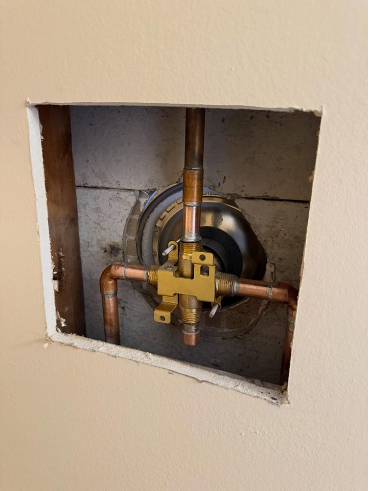 After: a new Delta shower valve with copper and ball valves inside the wall opening